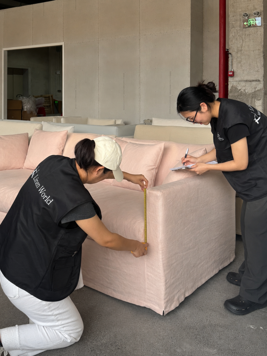 Linen World quality control inspection -- craftsman checking finished linen sofa